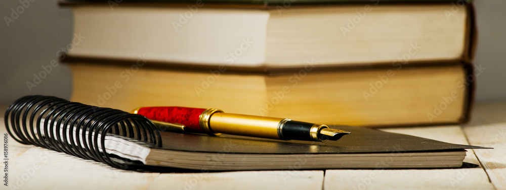 Wall mural image of books and pens close-up