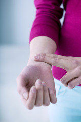 Woman taking her pulse