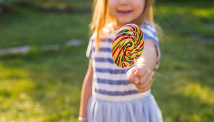 cute cauasian baby girl and big lollipop