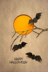 Happy halloween / Creative halloween concept photo of bats made of paper on brown background.