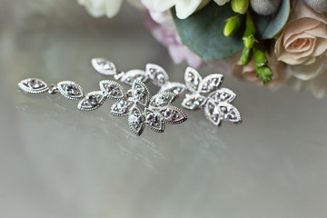 Earrings, bijouterie on a glass surface