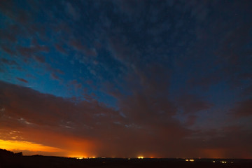 Clouds at night against the background of bright stars in the sky after sunset.