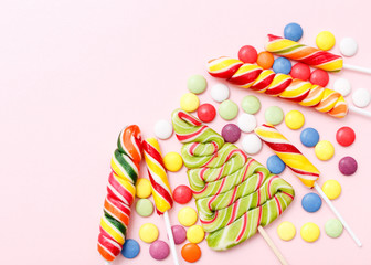 lollipops, candy, top view flat lay on pink background
