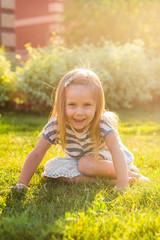 Cute little girl is playing in summer park