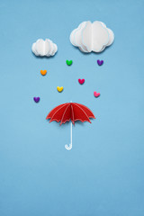 Raining love / Creative valentines concept photo of umbrella with hearts raining down on white background.