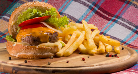 Burger and french fries on wooden table