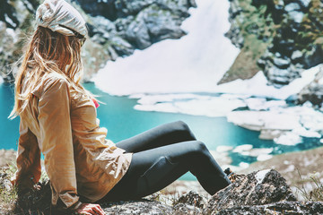 Hiker woman relaxing at blue lake in mountains Travel Lifestyle wanderlust concept summer vacations...
