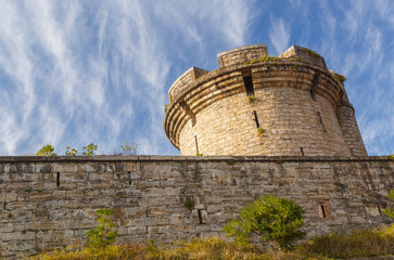Fototapeta na wymiar Ancient tower with stone wall