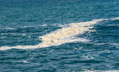 Seascape with pollution close-up on a water