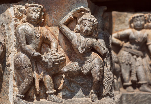 Ruined dancing people on relief of the 12th century Hoysaleshwara temple in Halebidu, India.