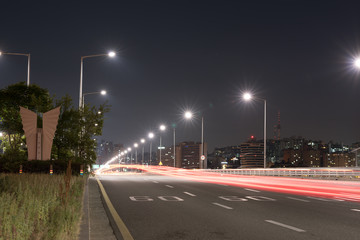 Fototapeta na wymiar night traffic on the highway, light trace from the traffic