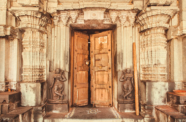 Indian traditional style design at entrance of historical Hindu temple with collumns and sculptures, India