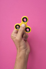 young man playing with a fidget spinner