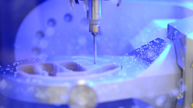 Dental milling machine carving out shape of human teeth close-up