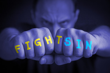 FIGHT SIN written on an angry man’s fists