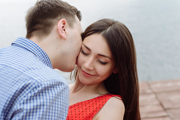 kiss. beautiful girl embraces the guy