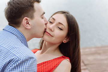 kiss. beautiful girl embraces the guy