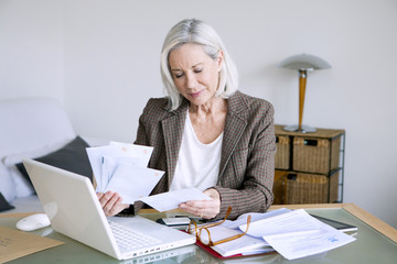 Senior woman working at home