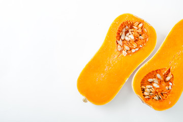 Butternut squash halved on white background with copy space. Organic food concept.