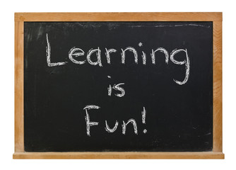 Obraz premium Learning is Fun written in white chalk on a black chalkboard isolated on white