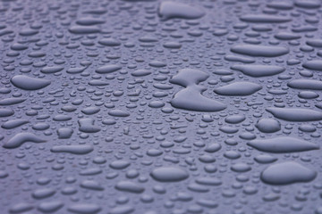 Drops of water on the car roof, abstract nature background
