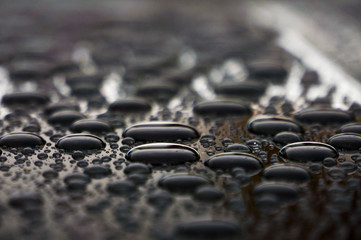 Drops of water on the car roof, nature background close up