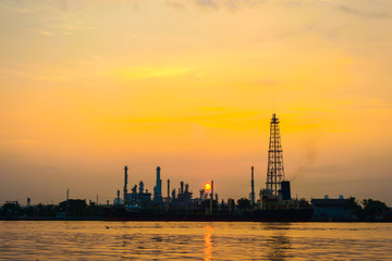 Fototapeta na wymiar Oil refinery petrochemical industry with river sunrise