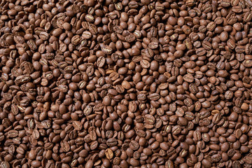 Roasted brown coffee beans, top view background