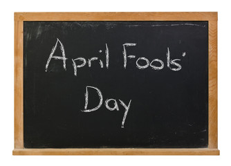 Obraz premium April Fools' Day written in white chalk on a black chalkboard isolated on white