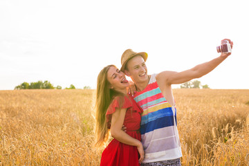 Young man and woman taking a selfie in the field