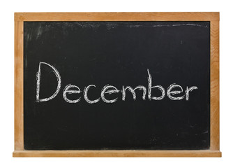 Obraz premium December written in white chalk on a black chalkboard isolated on white