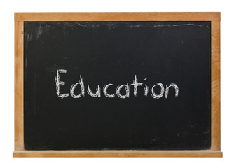 Fototapeta premium Education written in white chalk on a black chalkboard isolated on white