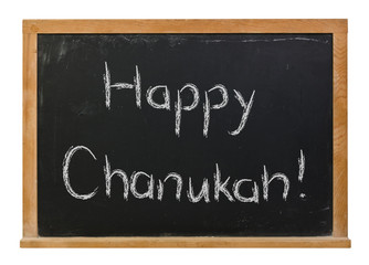 Obraz premium Happy Chanukah written in white chalk on a black chalkboard isolated on white