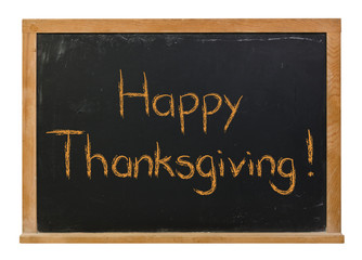 Obraz premium Happy Thanksgiving written in orange chalk on a black chalkboard isolated on white
