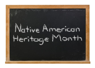 Obraz premium Native American Heritage Month written in white chalk on a black chalkboard isolated on white 