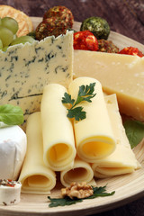 Cheese platter with different cheese and grapes