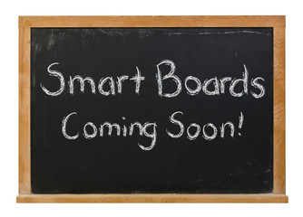 Smart boards coming soon written in white chalk on a black chalkboard isolated on white