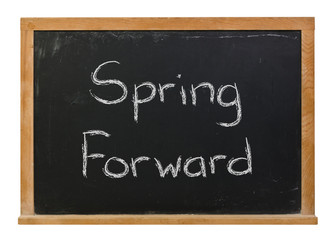 Obraz premium Spring Forward written in white chalk on a black chalkboard isolated on white