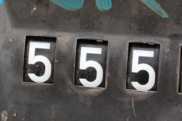 number 555 on old rusty counter of fuel pump