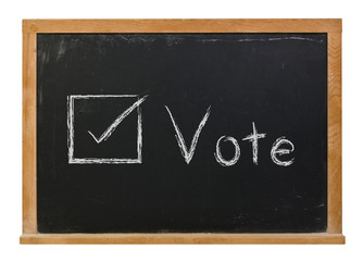 Vote written in white chalk on a black chalkboard isolated on white