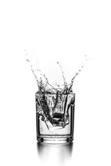 Isolated Water in a glass with splashes