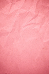 Crumpled recycle pink paper background.