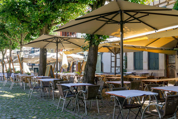 Street view of a coffee terrace with tables and chairs in europe
