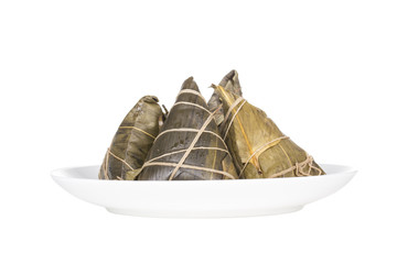 Chinese style rice dumplings or zongzi on a plate, and isolated on the white background.