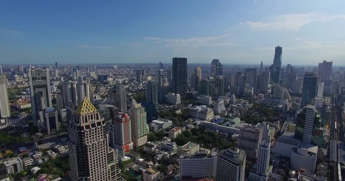 Aerial: Flight over skyscrapers in the center of Bangkok.