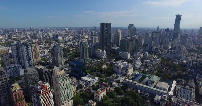 Aerial: View of the center of Bangkok, traffic and business buildings.