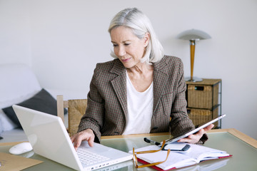 Senior woman working at home