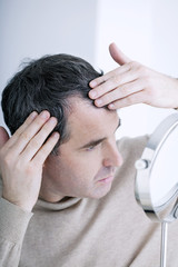 Man looking at himself in the mirror