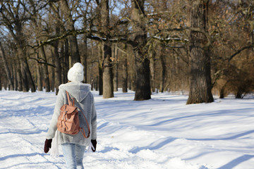 Girl walking in the forest park, winter, resting, recreation, healthy lifestyle