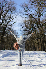 Resting woman in the park with his hands up, freedom, healthy lifestyle, natural background